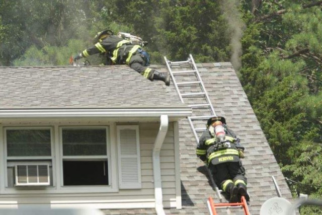 Structure fire on Magnolia Road July 12, 2008. FF/EMT Rebovich and FF/EMT Hoydis use a K-12 saw to vent the roof.